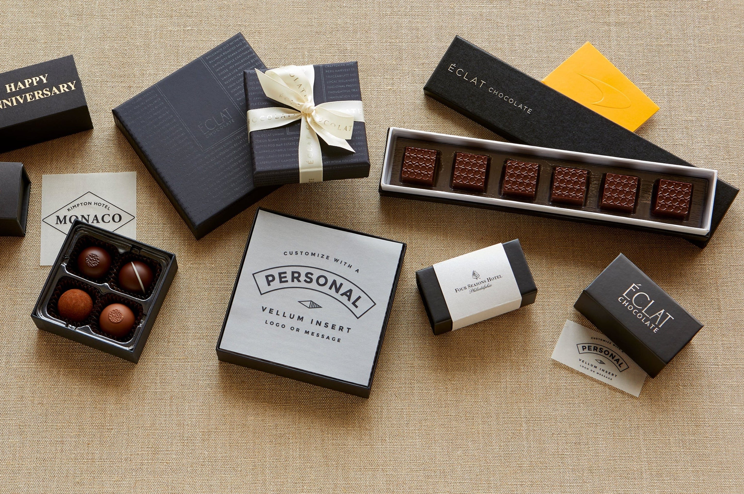 Assorted chocolate boxes and truffles on a textured surface