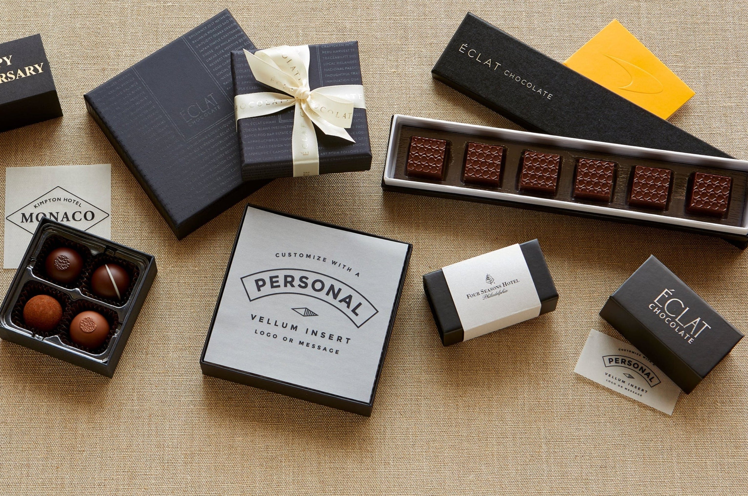 Assorted chocolate boxes and truffles on a textured surface
