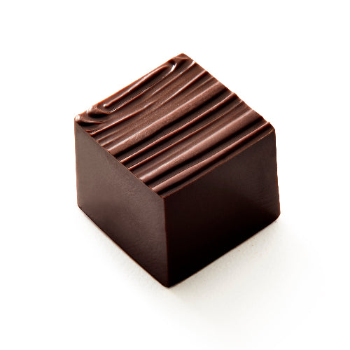 A single square dark chocolate candy with a ridged top surface, photographed on a clean white background.