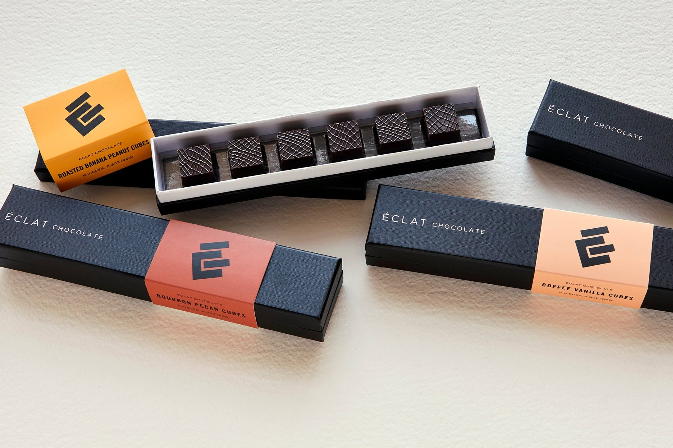 Eclat Chocolate packaging on a light wooden surface